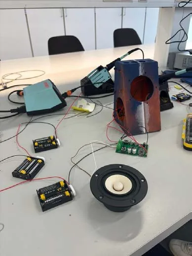 Workbench with driver, amplifier board, battery holders and a printed cabinet